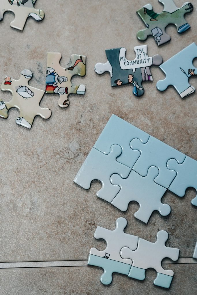 white-jigsaw-puzzle-pieces-on-brown-marble-table-sqjhky9877m